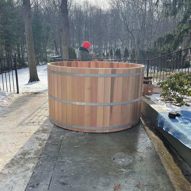 Wood Hot tub in rear of home behind iron gate