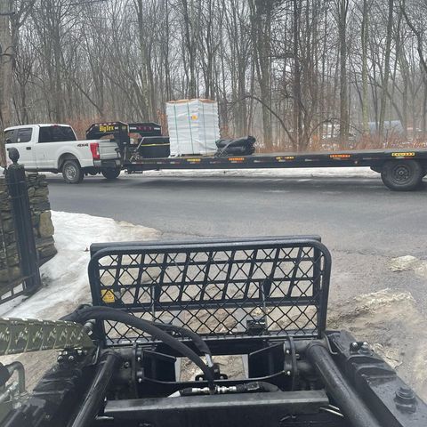 large truck holding wood pallet stacks