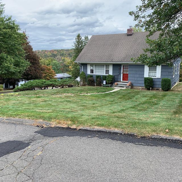 grass with gray house red door