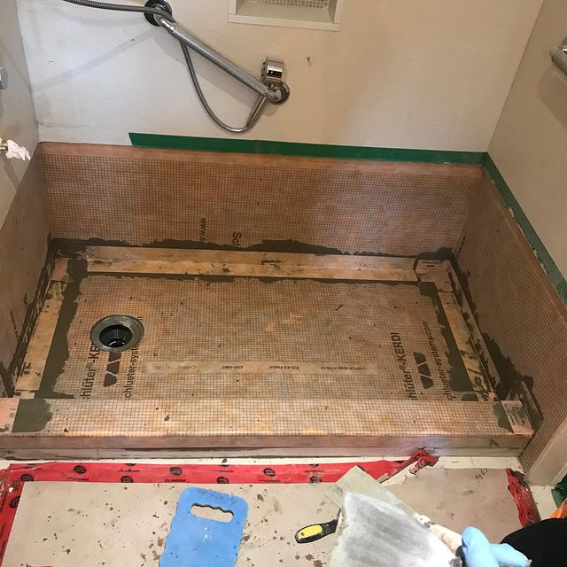 In progress image of a bathtub to shower conversion