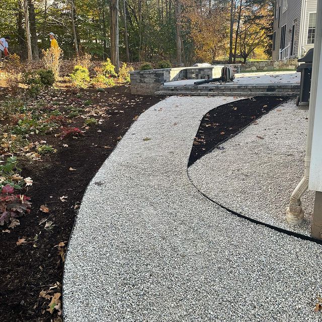 Rock pathway lined with mulched gardens