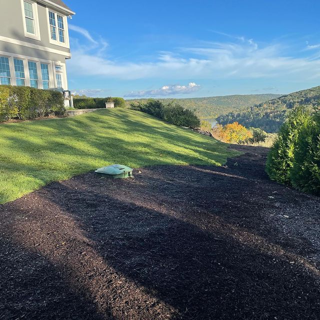 Beautiful view of 2 story home with fresh garden and green grass