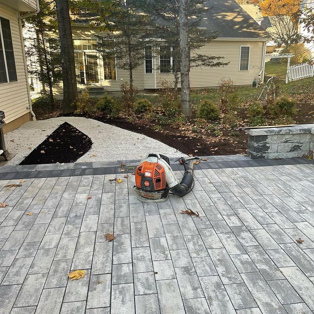 Deck leading out to rocked pathway lined with mulched garden