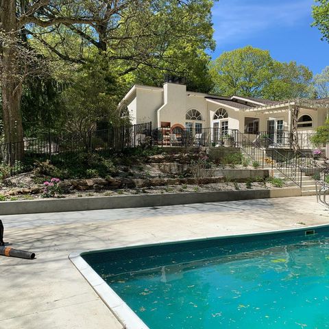 white house with pool and tiered yard