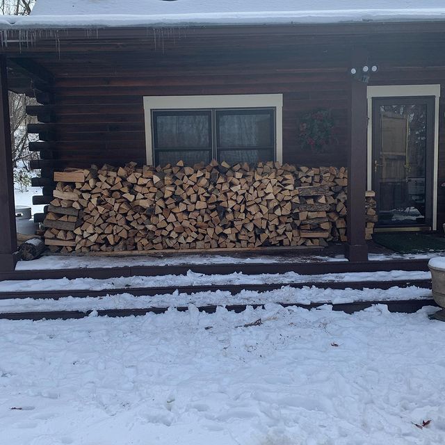wood stacked on porch with snow