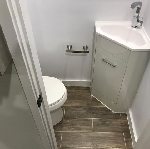 white bathroom with wooden flooring